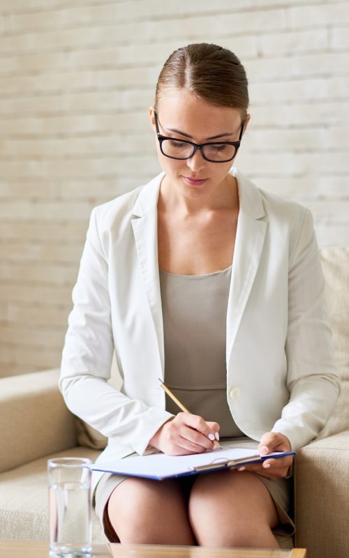 beautiful-female-psychiatrist-making-notes.jpg